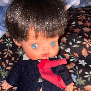 Adorable Doll with Red Scarf and Blue Eyes
